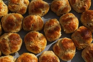 Delicious golden brown biscuits freshly baked and arranged on a tray under warm lighting.